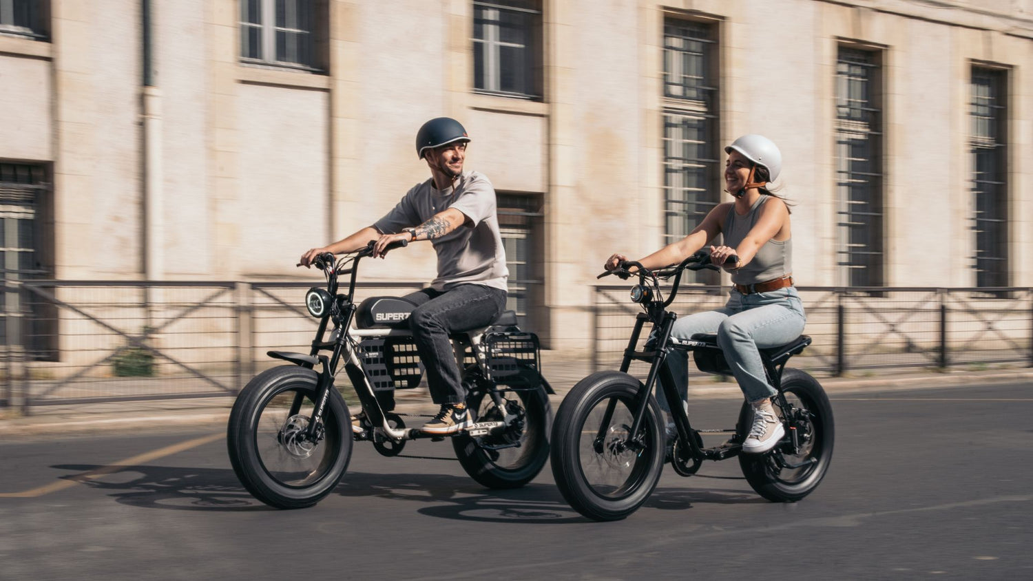 A man and a woman riding Super73 ebikes in Paris