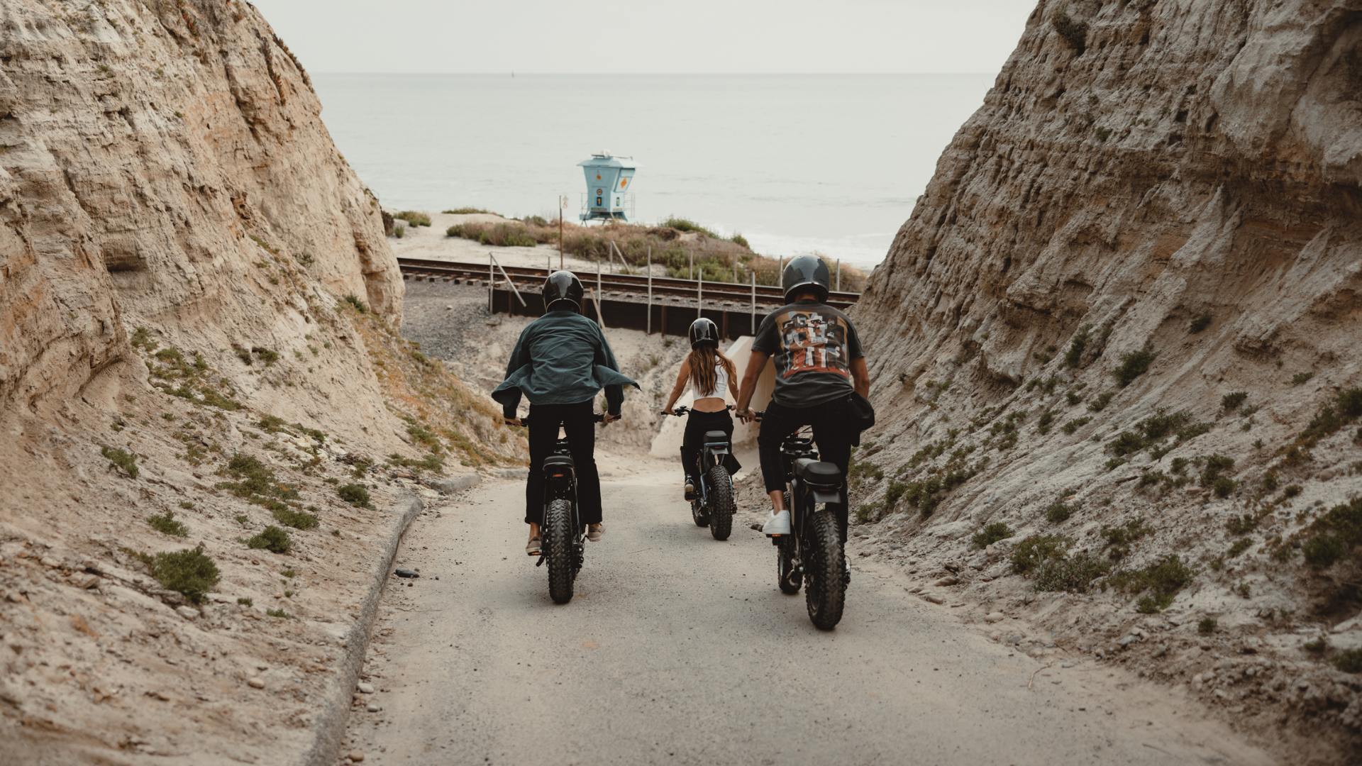 Three young people riding their Super73 Adventure Bikes in California