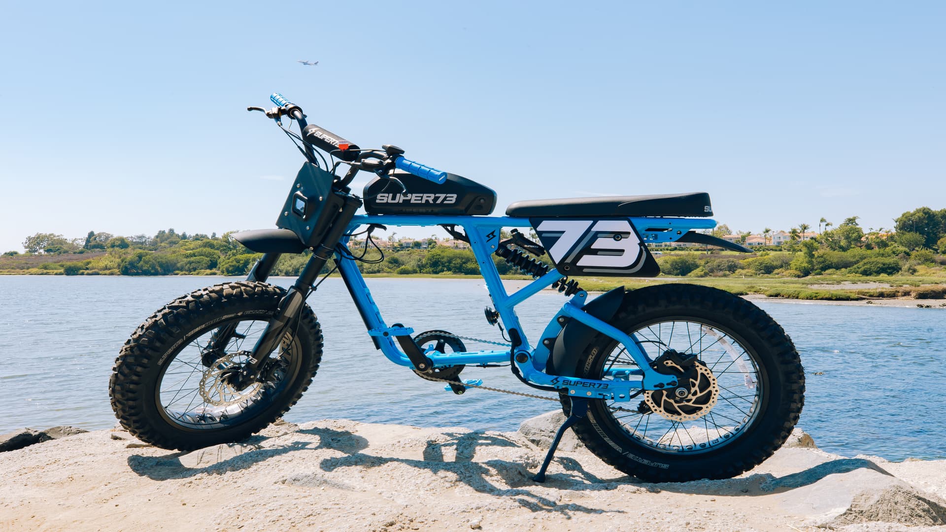 Super73-RX Blu Tang ebike on the shore of a lake