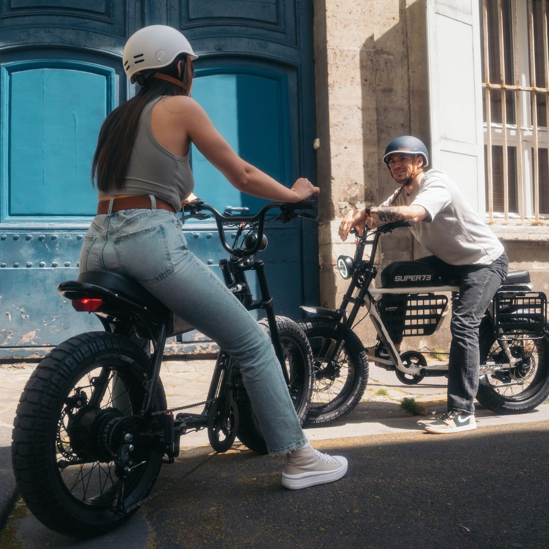 Man and woman riding Super73 ebikes in Paris